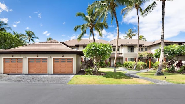 68-1122 Na Ala Hele Rd Unit F3, Kamuela, HI 96743 - view of front of property with a tiled roof, a front yard, and board and batten siding