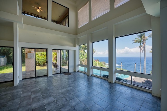 36-2335 Old Mamalahoa Hwy, Laupahoehoe, HI 96764 - empty room featuring a towering ceiling, a water view, healthy amount of natural light, and a ceiling fan