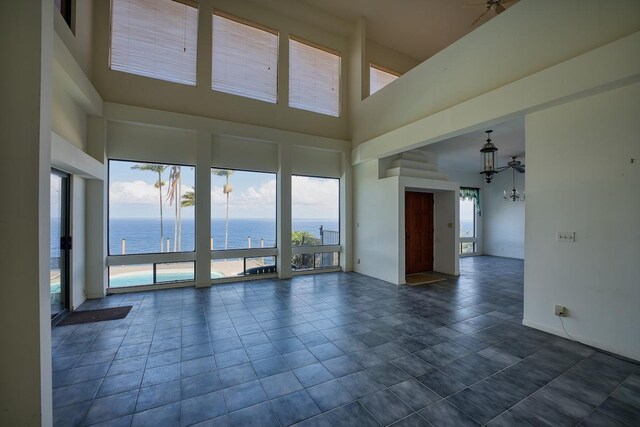 36-2335 Old Mamalahoa Hwy, Laupahoehoe, HI 96764 - unfurnished room featuring a water view, a chandelier, a high ceiling, and dark tile patterned floors