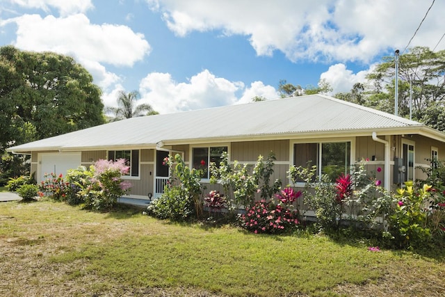 15-1798 20th Ave, Keaau, HI 96749 - view of front of house with an attached garage, a front lawn, metal roof, and a porch