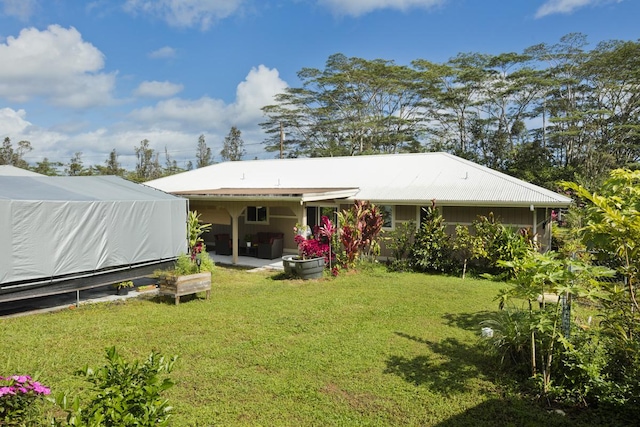 15-1798 20th Ave, Keaau, HI 96749 - rear view of property featuring a lawn, an outdoor hangout area, and a patio