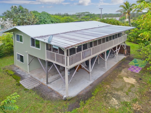 15-1565 Beach Rd, Keaau, HI 96749 - rear view of house with a patio, metal roof, and a sunroom