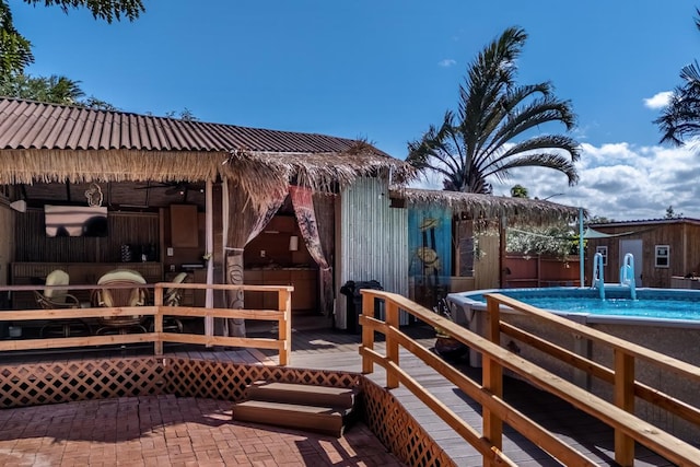 68-1842 Auhili Loop, Waikoloa, HI 96738 - back of property featuring an outdoor pool, a deck, and metal roof