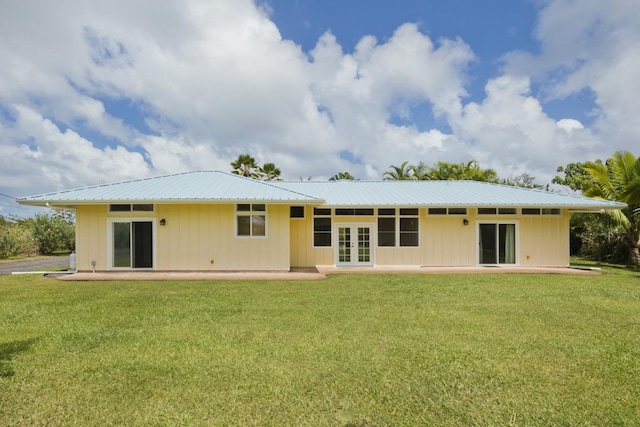 15-1612 3rd Ave, Keaau, HI 96749 - back of property with a lawn, french doors, and metal roof