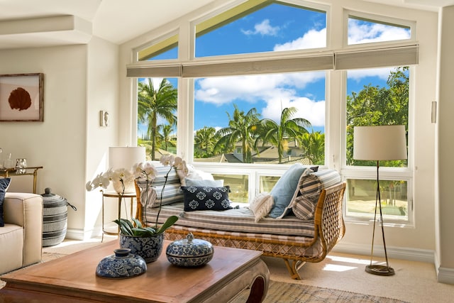 4100 Queen Emmas Dr Unit 64, Princeville, HI 96722 - living room with healthy amount of natural light, lofted ceiling, baseboards, and carpet flooring