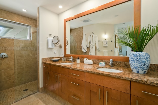 4100 Queen Emmas Dr Unit 64, Princeville, HI 96722 - bathroom featuring double vanity, a tile shower, and tile patterned floors