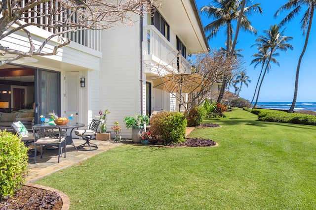 2221 Kapili Rd Unit 4, Koloa, HI 96756 - view of grassy yard with a balcony, a patio, and a water view