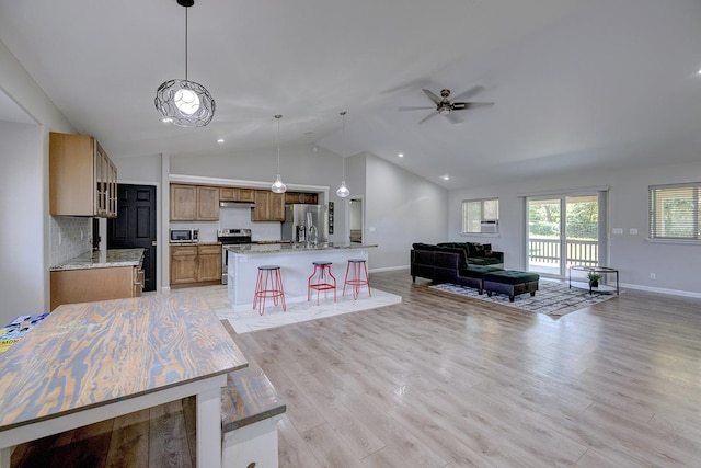 15-1888 22nd Ave, Keaau, HI 96749 - kitchen with appliances with stainless steel finishes, open floor plan, vaulted ceiling, ceiling fan, and light wood-style flooring