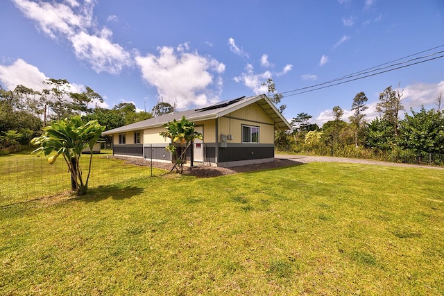 15-1888 22nd Ave, Keaau, HI 96749 - view of side of home with roof mounted solar panels and a yard