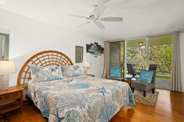 3811 Edward Rd Unit 1108, Princeville, HI 96722 - bedroom with access to outside, wood finished floors, floor to ceiling windows, a textured ceiling, and ceiling fan