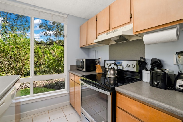3811 Edward Rd Unit 1108, Princeville, HI 96722 - kitchen with appliances with stainless steel finishes, under cabinet range hood, light tile patterned floors, and plenty of natural light