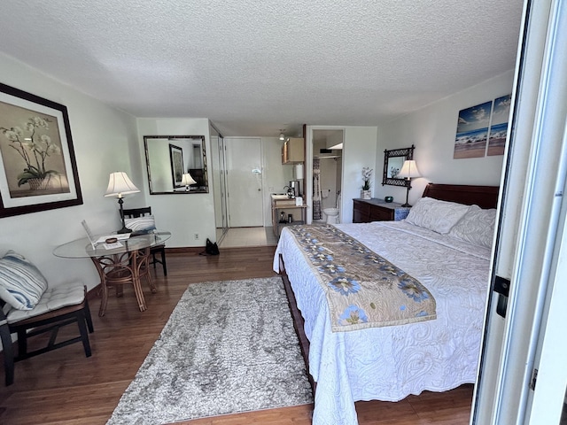 3811 Edward Rd Unit 1108, Princeville, HI 96722 - bedroom featuring a textured ceiling and dark wood-style floors