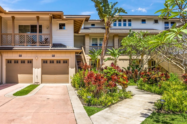2611 Kiahuna Plantation Dr Unit 15F, Koloa, HI 96756 - view of property with concrete driveway, board and batten siding, a garage, and a balcony