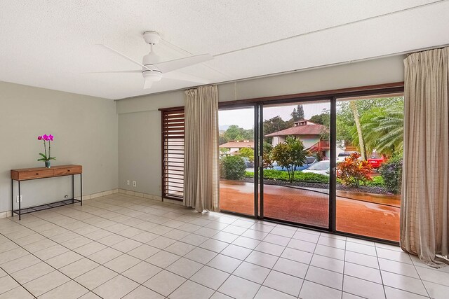 4701 Kawaihau Rd Unit A101, Kapaa, HI 96746 - unfurnished room with ceiling fan, a textured ceiling, light tile patterned floors, and baseboards