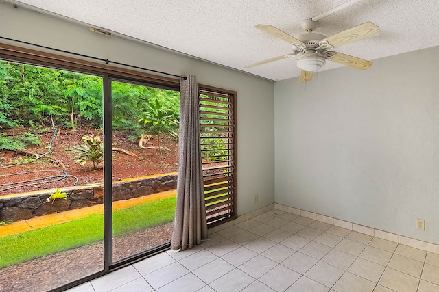 4701 Kawaihau Rd Unit A101, Kapaa, HI 96746 - empty room featuring light tile patterned floors, a textured ceiling, ceiling fan, and baseboards