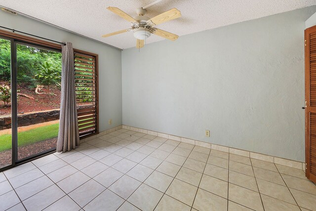 4701 Kawaihau Rd Unit A101, Kapaa, HI 96746 - empty room featuring a ceiling fan, a textured ceiling, and light tile patterned floors
