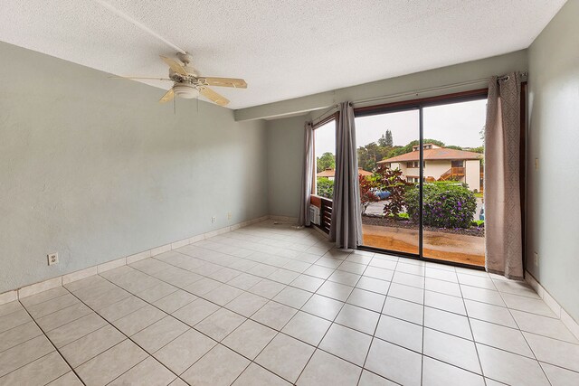 4701 Kawaihau Rd Unit A101, Kapaa, HI 96746 - empty room with a textured ceiling, a ceiling fan, light tile patterned floors, and baseboards