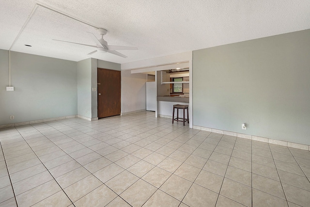 4701 Kawaihau Rd Unit A101, Kapaa, HI 96746 - spare room featuring a ceiling fan, a textured ceiling, light tile patterned floors, and baseboards