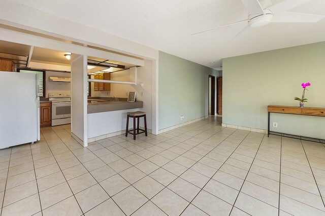 4701 Kawaihau Rd Unit A101, Kapaa, HI 96746 - unfurnished living room with a ceiling fan and light tile patterned floors