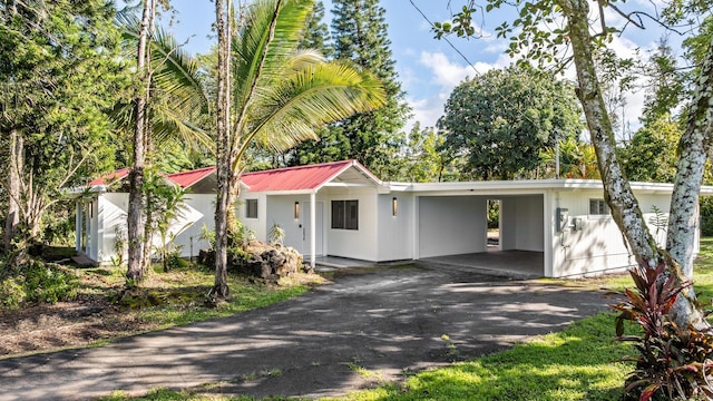 15-2774 Ahi St, Pahoa, HI 96778 - view of front of home with asphalt driveway, a carport, and metal roof