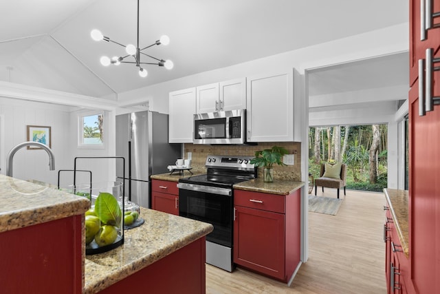 15-2774 Ahi St, Pahoa, HI 96778 - kitchen featuring appliances with stainless steel finishes, a chandelier, decorative backsplash, lofted ceiling, and light wood-style flooring