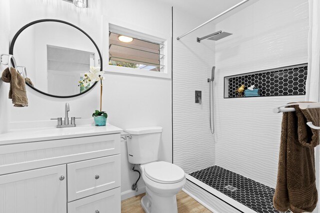 15-2774 Ahi St, Pahoa, HI 96778 - bathroom featuring vanity, toilet, tiled shower, and wood finished floors