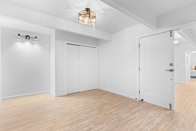 15-2774 Ahi St, Pahoa, HI 96778 - unfurnished bedroom featuring light wood-style floors, baseboards, and a chandelier