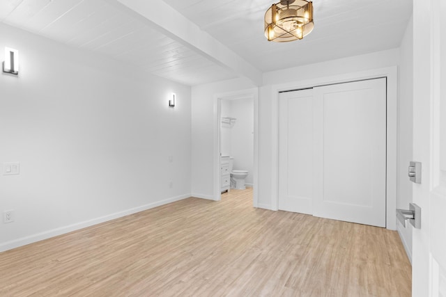 15-2774 Ahi St, Pahoa, HI 96778 - unfurnished bedroom featuring light wood finished floors, a closet, baseboards, beamed ceiling, and connected bathroom