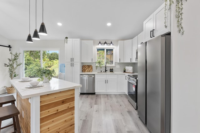 16-2050 Pikake Dr, Pahoa, HI 96778 - kitchen featuring stainless steel appliances, white cabinetry, backsplash, light countertops, and recessed lighting