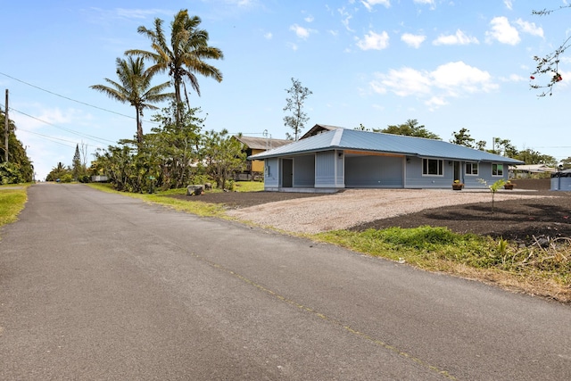 16-2050 Pikake Dr, Pahoa, HI 96778 - view of front of home with dirt driveway, a metal roof, and a carport
