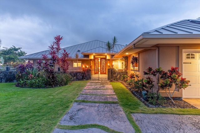 75-665 Kula Kai Pl, Kailua-Kona, HI 96740 - view of front of home with a standing seam roof, a front lawn, a metal roof, and stucco siding