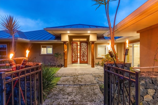 75-665 Kula Kai Pl, Kailua-Kona, HI 96740 - property entrance featuring a standing seam roof, a metal roof, stucco siding, and a gate