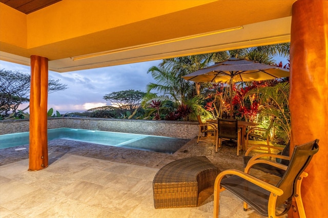75-665 Kula Kai Pl, Kailua-Kona, HI 96740 - patio terrace at dusk featuring a patio area, outdoor dining area, and an outdoor pool
