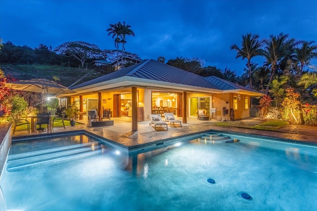 75-665 Kula Kai Pl, Kailua-Kona, HI 96740 - pool at night with an outdoor pool and a patio area