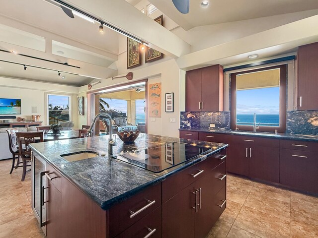 75-5952 Alii Dr, Kailua-Kona, HI 96740 - kitchen featuring black electric cooktop, lofted ceiling, backsplash, a sink, and plenty of natural light