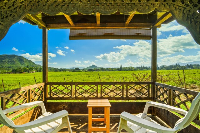 6161 Holio Rd, Kapaa, HI 96746 - wooden terrace featuring a view of rural / pastoral area, a mountain view, and a lawn