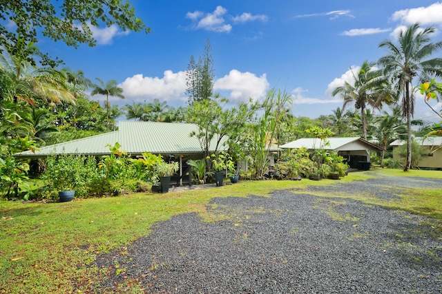 16-1381 Pohaku Cir, Keaau, HI 96749 - view of front of house featuring metal roof, driveway, and a carport