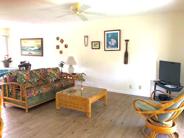 78-7054 Kamehameha Iii Rd Unit 1203, Kailua-Kona, HI 96740 - living area featuring wood-type flooring, a ceiling fan, and baseboards