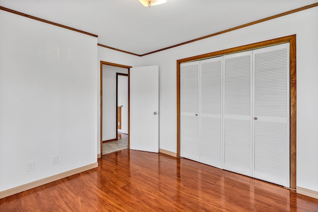 64-5270 Hoohoa St, Kamuela, HI 96743 - unfurnished bedroom with wood finished floors, baseboards, ornamental molding, and a closet