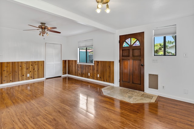 64-5270 Hoohoa St, Kamuela, HI 96743 - foyer entrance with wainscoting, wood finished floors, a ceiling fan, wooden walls, and baseboards