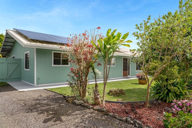 64-5270 Hoohoa St, Kamuela, HI 96743 - rear view of property featuring solar panels, a gate, metal roof, and a yard