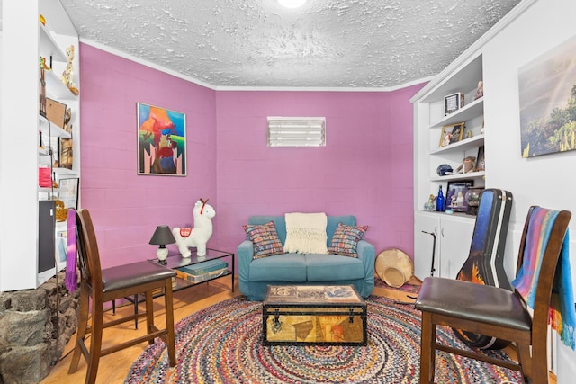 15-1913 Beach Rd, Keaau, HI 96749 - living room with wood finished floors, a textured ceiling, crown molding, concrete block wall, and built in shelves