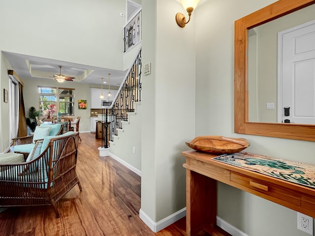 68-1125 Kaniku Dr Unit 1601, Kamuela, HI 96743 - hallway featuring wood finished floors, stairs, and baseboards
