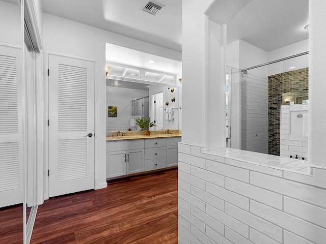 68-1125 Kaniku Dr Unit 1601, Kamuela, HI 96743 - bathroom with a tile shower, double vanity, and wood finished floors