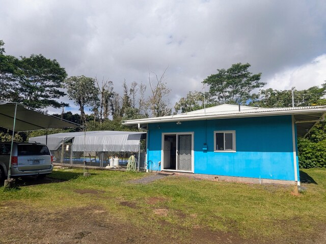 15-1468 23rd Ave, Keaau, HI 96749 - view of front of home featuring a front lawn and metal roof