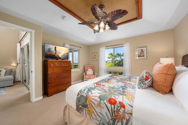 68-1122 Na Ala Hele Rd Unit H22, Kamuela, HI 96743 - bedroom with light carpet, a tray ceiling, a ceiling fan, and baseboards