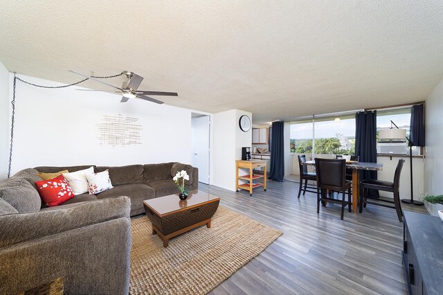 84 Pukihae St Unit 1106, Hilo, HI 96720 - living area with a textured ceiling, wood finished floors, and a ceiling fan