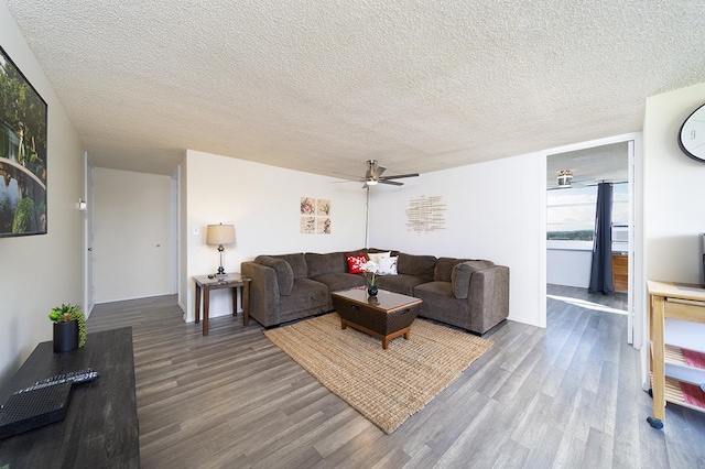 84 Pukihae St Unit 1106, Hilo, HI 96720 - living area featuring wood finished floors, a ceiling fan, a textured ceiling, and baseboards