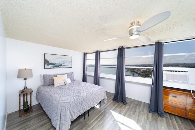 84 Pukihae St Unit 1106, Hilo, HI 96720 - bedroom with a textured ceiling, wood finished floors, and a ceiling fan