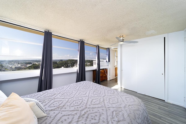 84 Pukihae St Unit 1106, Hilo, HI 96720 - bedroom featuring wood finished floors, a textured ceiling, and a closet